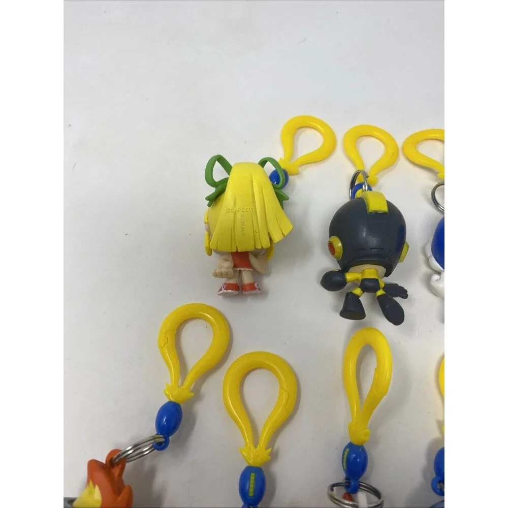 lot of 9 CAPCOM MEGA MAN BACKPACK HANGERS METALLIC FIRE MAN JUST TOYS INTL.